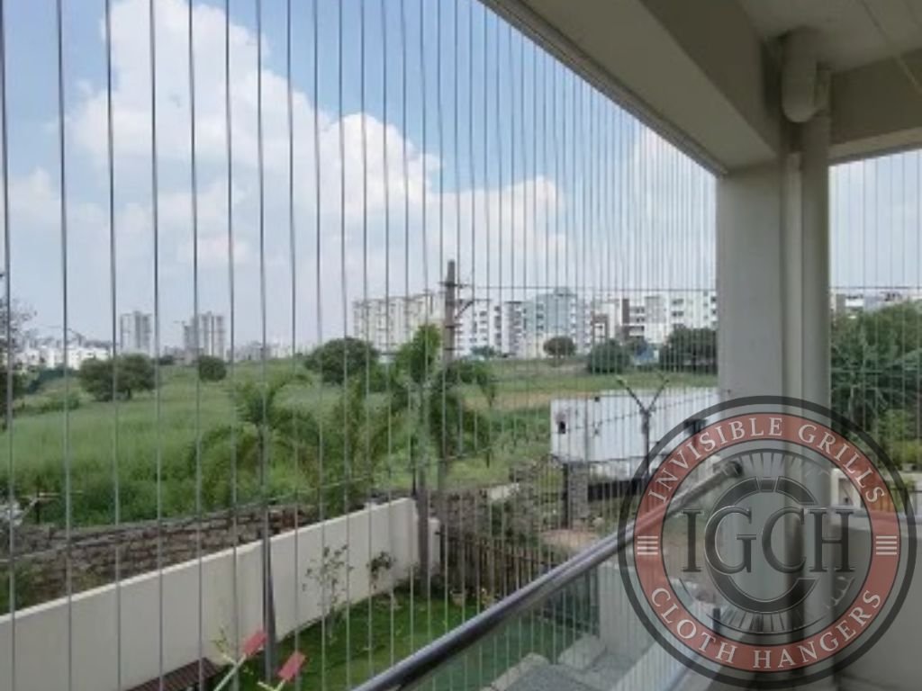 Invisible safety grills installed on high-rise balcony for safety and security in Nizamabad